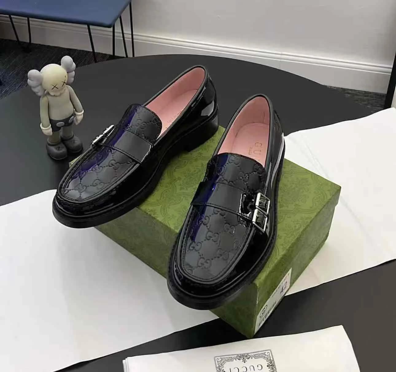 Gucci Monogram-Debossed Leather Loafers